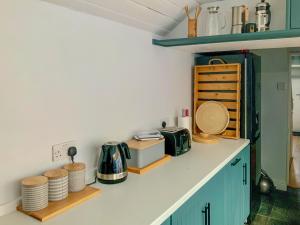 a kitchen with blue cabinets and a counter top at Llwyndre in Ederyn