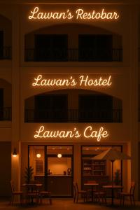 a restaurant with tables and chairs in front of a building at Lawans Hostel in Pattaya South