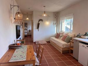 a living room with a table and a couch at טרקוטה in Odem +11 photos