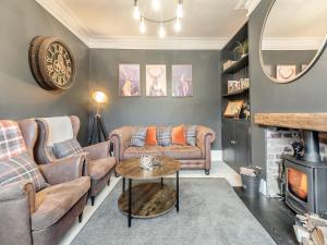 a living room with couches and a fireplace at Skye House in Bakewell