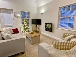 a living room with a christmas tree and a television at The Guards Quarters - Uk47594 in Silloth
