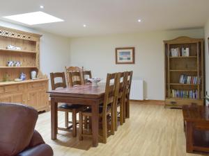 a dining room with a wooden table and chairs at The Old Dairy - Ukc3413 in Bolton by Bowland