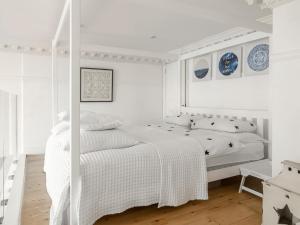 a white bedroom with a white bed and white walls at The Little Beach House in Brighton & Hove