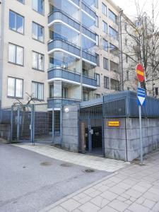 a building with a blue fence in front of a building at City Center apartment at the Bus Station With balcony and sauna in Turku