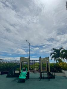 a playground with a green slide on the beach at CDO Nest in Cagayan de Oro +34 photos