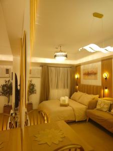 a bedroom with a bed and a couch at CDO Nest in Cagayan de Oro
