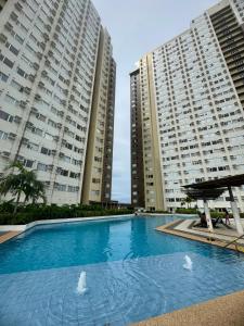 a swimming pool in front of two tall buildings at CDO Nest in Cagayan de Oro