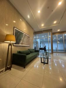 a living room with a green couch and a table at CDO Nest in Cagayan de Oro +31 photos