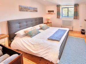 a large bed with white sheets and pillows in a bedroom at Madeline Angevine - Ukc3208 in Newbridge