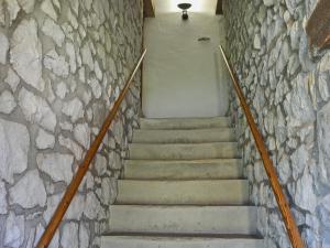 a stairway with a stone wall and a stair case at Barn End Cottage in Millers Dale