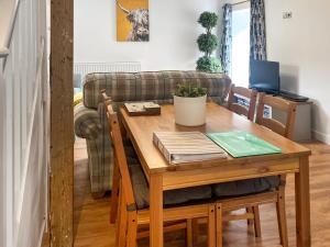 a living room with a table and a couch at The Barn in Llangwm