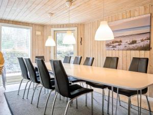 a conference room with a long table and chairs at 12 person holiday home in Nexø in Snogebæk