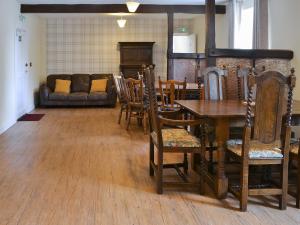 a living room with a table and chairs and a couch at Blaithwaite Stables in Blencogo
