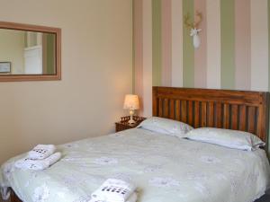 a bedroom with a bed with two towels on it at Blaithwaite Stables in Blencogo +8 photos