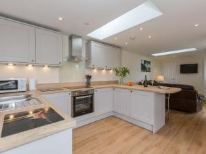 a kitchen with white cabinets and a counter top at Sherwood Forest Lodge 1 in Clipstone