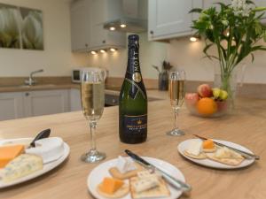 a table with a bottle of champagne and two glasses at Sherwood Forest Lodge 1 in Clipstone +19 photos