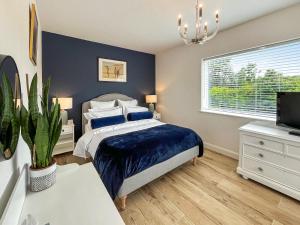 a bedroom with a bed and a tv and a window at Wyn Shiels Hide Away in Ainstable