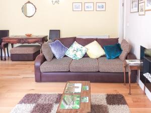 a living room with a couch with pillows on it at Little Acorns in Great Malvern