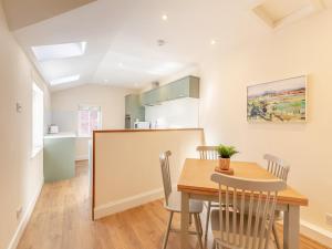 a kitchen and dining room with a table and chairs at The Old Bakery - Uk48319 in Berwick-Upon-Tweed