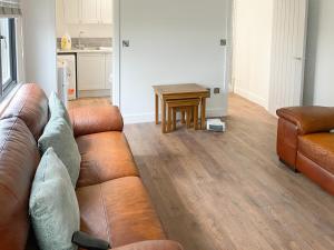 a living room with a couch and a table at The Cabin in Southbourne