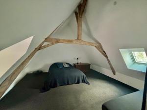 a bedroom with a bed in a attic at Welcome to SWEET HOME in Bélâbre
