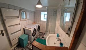a bathroom with a sink and a washing machine at Welcome to SWEET HOME in Bélâbre +45 photos
