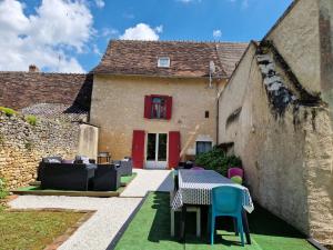 a patio with a table and chairs in front of a building at Welcome to SWEET HOME in Bélâbre