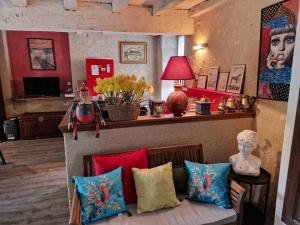 a living room with a couch with colorful pillows at Welcome to SWEET HOME in Bélâbre