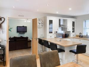 a kitchen and living room with a table and chairs at The Old Forge in Alnwick