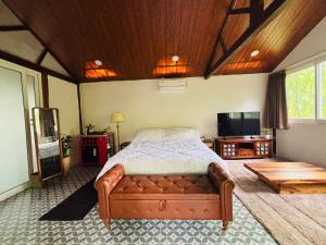 a bedroom with a bed and a tv in it at Indulge House in Revora