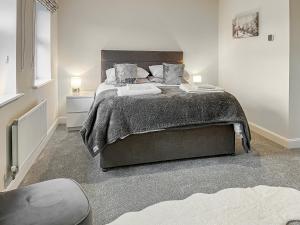 a bedroom with a large bed in a room at Crawshaw Cottage in Buxton