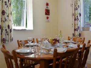 a dining room table with chairs and glasses on it at Green Valley Retreat in Holsworthy