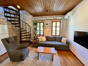 a living room with a couch and a table at Our Townhouse in Gjirokastër