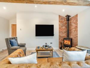 a living room with a couch and a fireplace at The Workshop - Uk42470 in Middleton