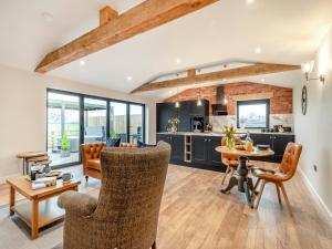 a kitchen and living room with a table and chairs at The Workshop - Uk42470 in Middleton
