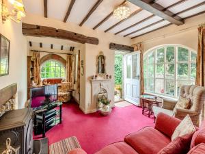 a living room with a couch and a tv at Rose Cottage - Lpd in Ireby
