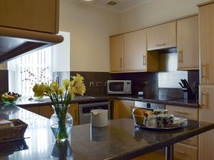 a kitchen with a bowl of food on a counter at Horsemill - Uk10794 in Ballingry