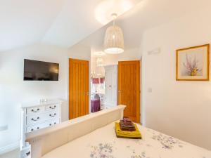 een witte kamer met een dressoir en een spiegel bij Adair Cottage in Wigglesworth
