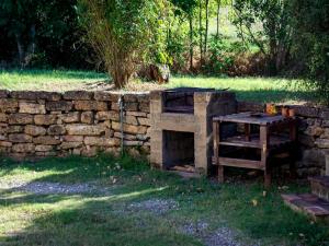 a brick fireplace with a table next to a stone wall at Villa in Tuscany near Medieval Ghizzano in Ghizzano