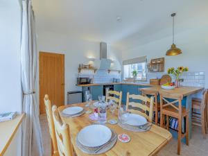 a kitchen and dining room with a table and chairs at Swallow - Uk50155 in Faversham