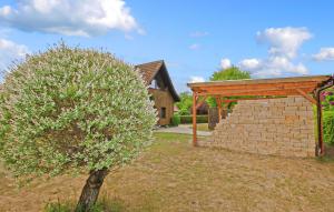 a tree next to a brick wall and a pavilion at Ferienwohnung Zislow in Zislow