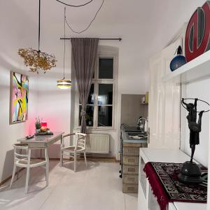 a kitchen with a table and chairs in a room at Palais am Park in Krems an der Donau