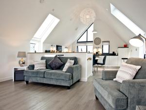 a living room with a couch and a chair at Black Sea Horse in Westward Ho +29 photos