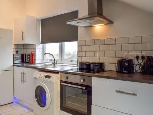 a kitchen with a sink and a washing machine at Apartment 6 - Uk48914 in Huddersfield