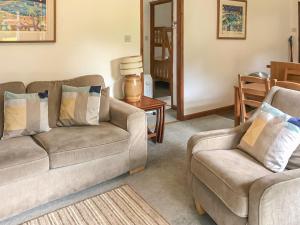 a living room with two couches and a chair at The Lodge in Uny Lelant
