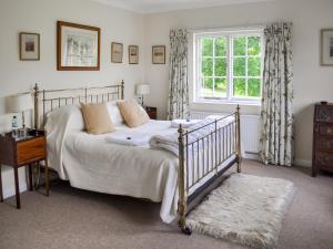 a bedroom with a bed and a window at Glanusk Lodge - Uk46654 in Crickhowell