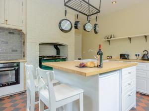 a kitchen with a counter with a bottle of wine at Station House in Millers Dale