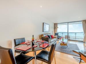 a living room with a table and chairs and a couch at Apartment 50 in Westward Ho