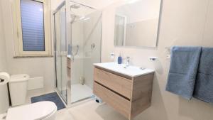 a bathroom with a sink and a shower and a toilet at Riva di Davoli One Bedroom Apartment in Marina di Davoli +26 photos