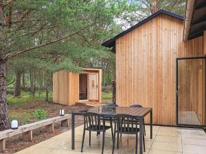 a table and chairs on a patio with a building at 8 person holiday home in Ålbæk in Ålbæk